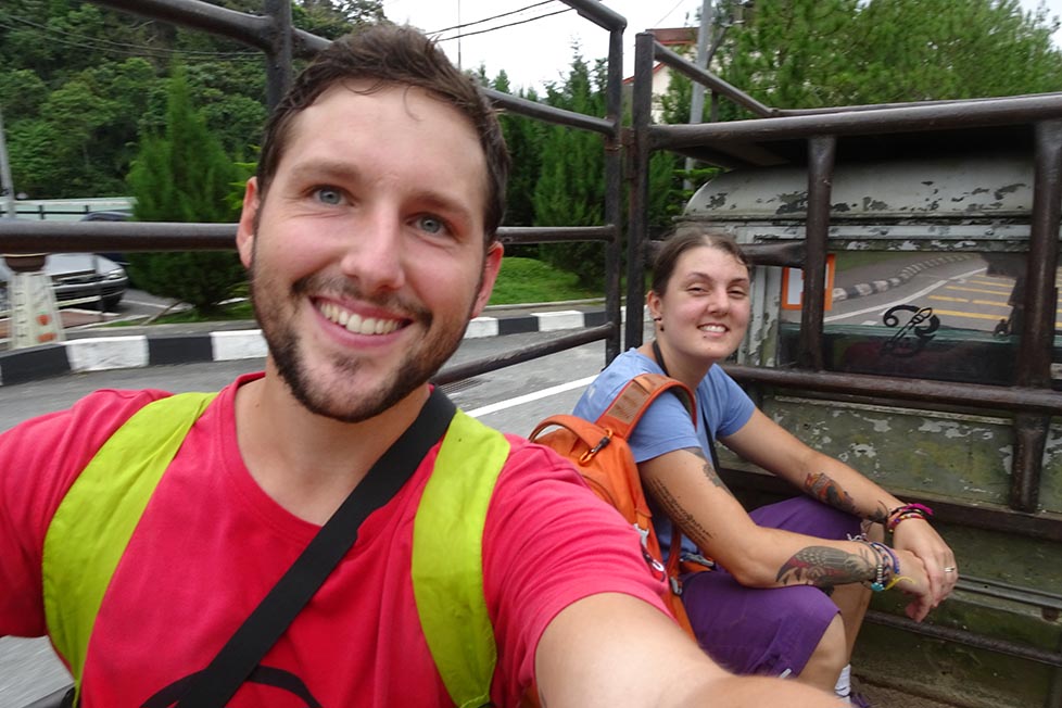 Nic and Shorty hitchhiking on the back of a pick up truck Guide to public transport in Albania and renting a car and hitchhiking