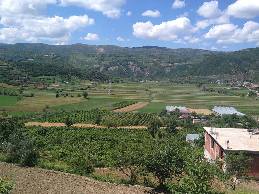 Mountains and fields in the middle of nowhere in Albania Guide to public transport in Albania and renting a car and hitchhiking