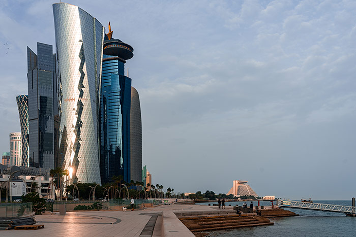 The path down the corniche next to the harbour in Doha, Qatar with the sky scrapers of West Bay on one side