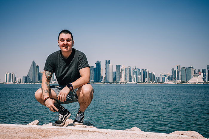 Nic kneeling on the bay near MIA across from West Bay in Doha, Qatar.