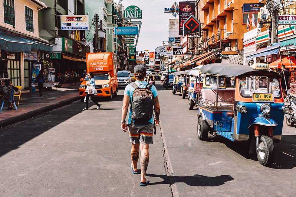 Nic walking past some Tuk Tuks on Khao San Road in Bangkok, Thailand