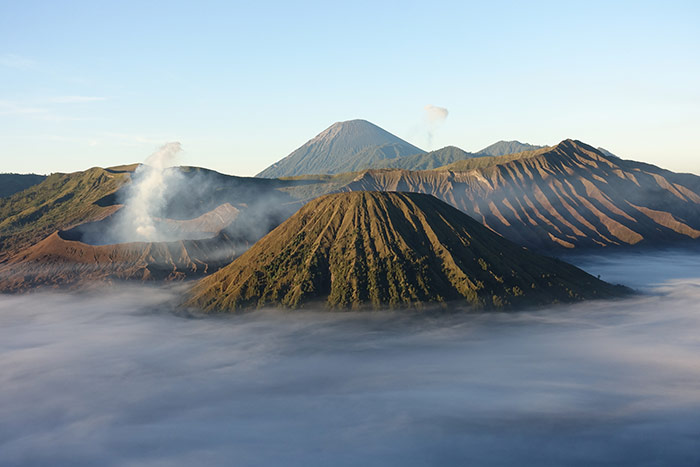 The view out over a missy valley to Mt Bromo, an active volcano in Java, Indonesia