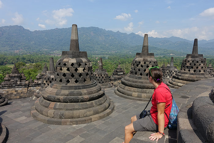 Nic sitting looking out over the massive stupas of Borobudur temple near Yogyakarta, Indonesia