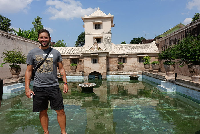 Shorty standing next to the main pool at the Water castle (Taman Sari) in Yogyakarta, Indonesia