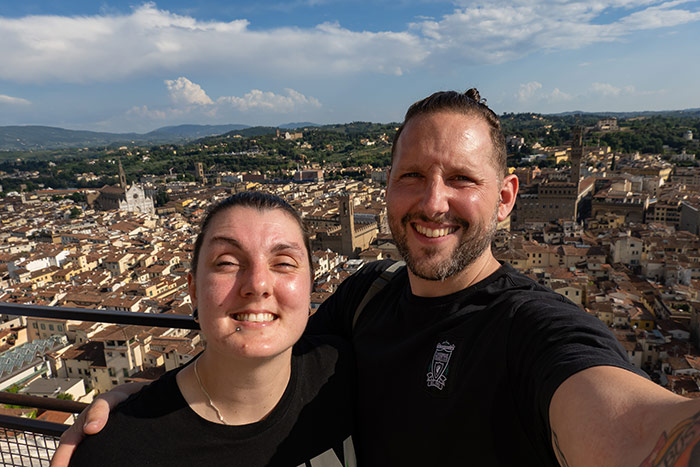 Nic and Shorty taking a selfie in Florence, Italy off the top of the Duomo with the rooftops of the city seen below. best city breaks Europe for couples