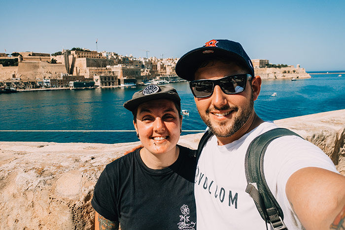 Nic and Shorty taking a selfie with Valletta harbour in the background with blue sea in Malta
