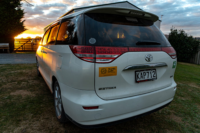 A camper van at sunset on a farm campsite near Hobbiton in New Zealand