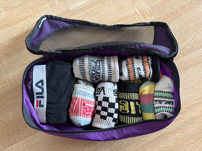 Nic's underwear packing cube which is open and has 7 pairs of knickers and socks inside.